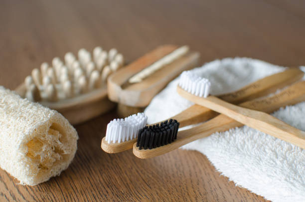 istock Three Bamboo toothbrushes with towel and eco natural plastic free luffa, brushes on the background 1127556548