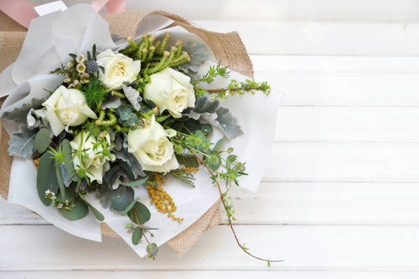 istock White roses bouquet on white background 1127556691
