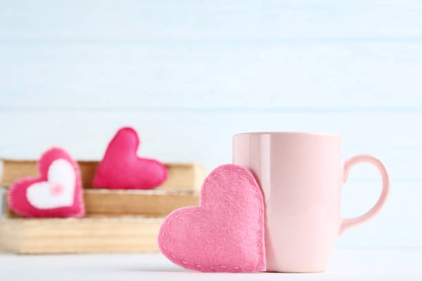 istock Fabric hearts with cup on wooden table 1127556843