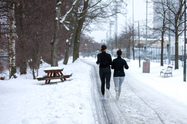 istock Two girlfriends are jogging in sports clothes 1127557067