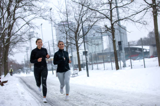 istock Two girlfriends are jogging in sports clothes 1127557086
