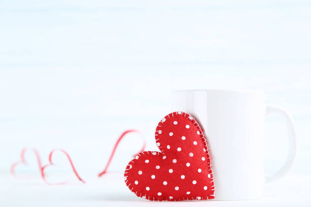 istock Fabric heart with cup on wooden table 1127557212