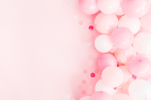 Balloons on pastel pink background. Frame made of white and pink balloons. Birthday, valentines day, holiday concept. Flat lay, top view, copy space