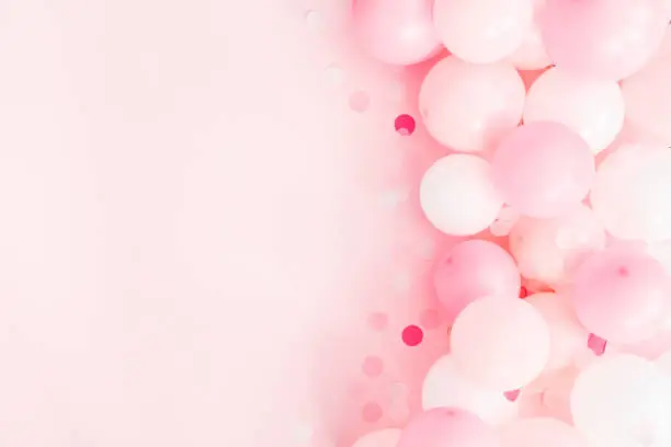 Photo of Balloons on pastel pink background. Frame made of white and pink balloons. Birthday, valentines day, holiday concept. Flat lay, top view, copy space