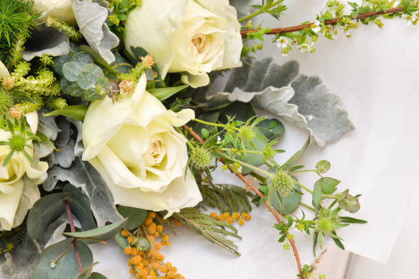 istock White roses bouquet on white background 1127562326