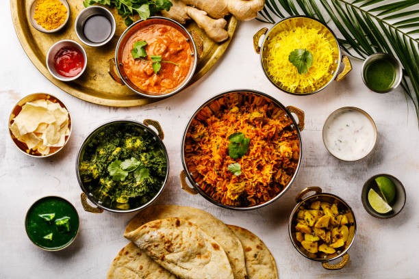 Indian food Curry butter chicken, Palak Paneer, Chiken Tikka, Biryani, Papad, Dal, Rice with Saffron and Naan bread on white background stock photo