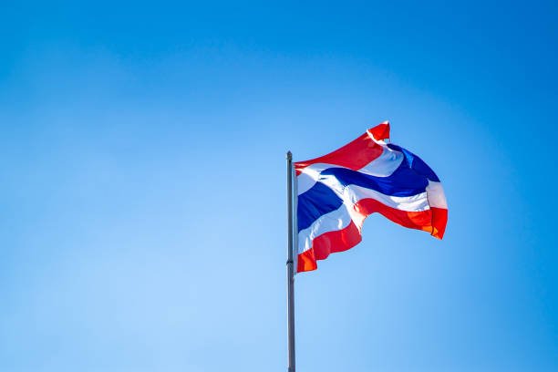 istock Thai flag nation on blue sky background 1127564670