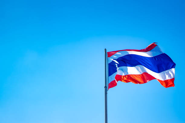 istock Thai flag nation on blue sky background 1127564672