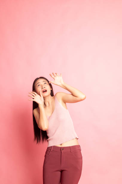 istock Excited young Asian woman look up. 1127564703