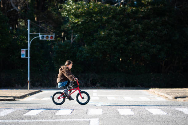 istock Girl across the intersection by bicycle 1127565135