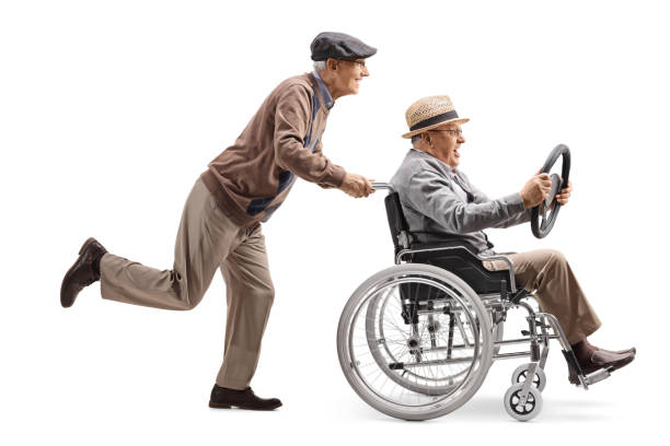 vieil homme poussant un homme assis dans un fauteuil roulant et tenant un volant d�’une voiture - physical injury men orthopedic equipment isolated on white photos et images de collection
