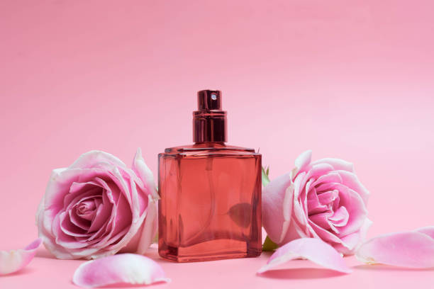 istock Beautiful perfume bottles on pink background 1127565472