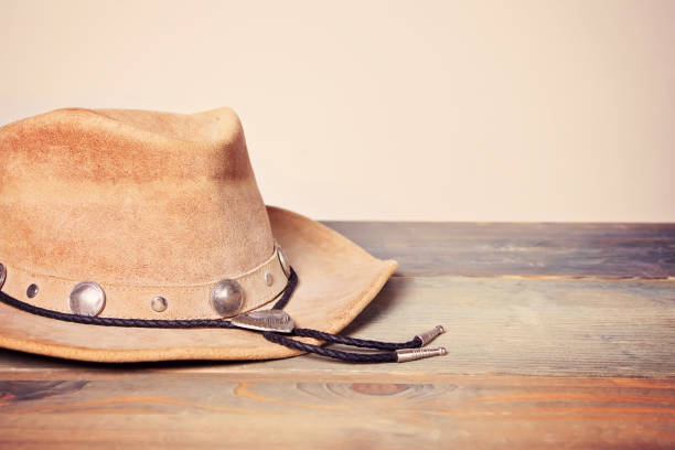 istock Brown cowboy hat on a wooden table 1127565587