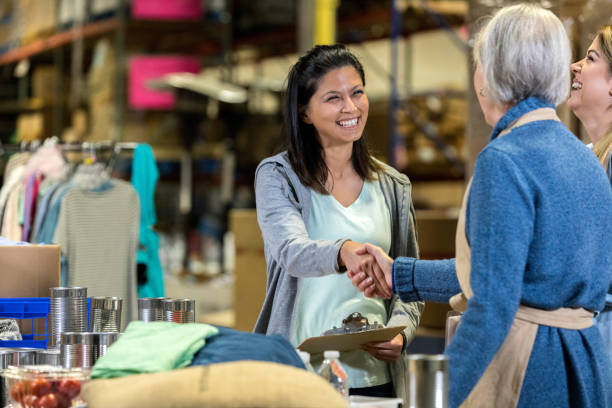 istock Food bank director greets volunteer 1127566190