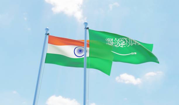 istock Saudi Arabia and India, two flags waving against blue sky 1127566238