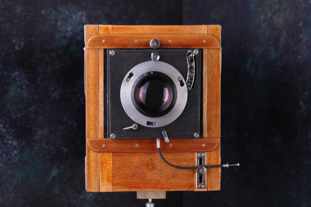 istock Vintage wooden camera with shutter on a cement background. The old studio camera for using plates. 1127567629