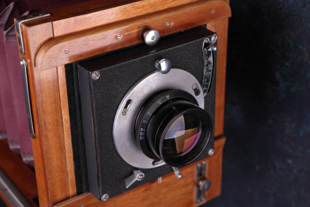 Vintage wooden camera with shutter on a cement background. The old studio camera for using plates.
