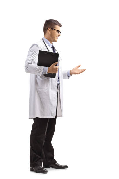 istock Young male doctor in a lab coat standing and gesturing a conversation 1127567847