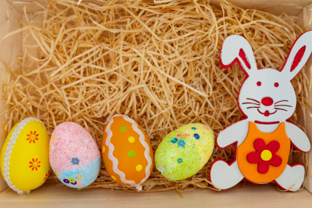 istock Easter rabbit and eggs with colorful eggs around and white background 1127567938