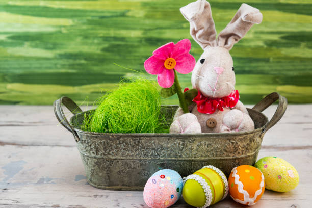 istock Easter rabbit and eggs with colorful eggs around and white background 1127567973