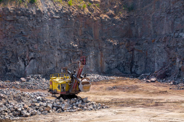 istock A large tracked excavator in a quarry open pit mining of granite stone. Process production stone and gravel. Quarry mining equipment. 1127568035