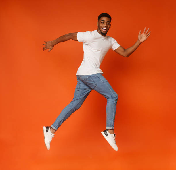 istock Funny young black man walking on air 1127568130
