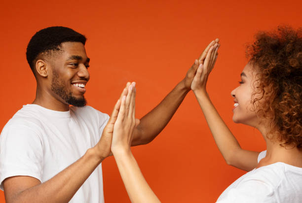 istock Happy black man and woman clapping their hands 1127568143