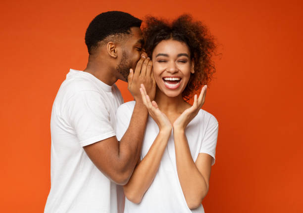 istock Black man sharing secret with his girlfriend 1127568152