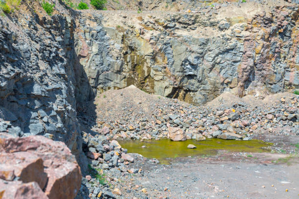istock Spectacular view of quarry open pit mining of granite stone. Process production stone and gravel. 1127568328