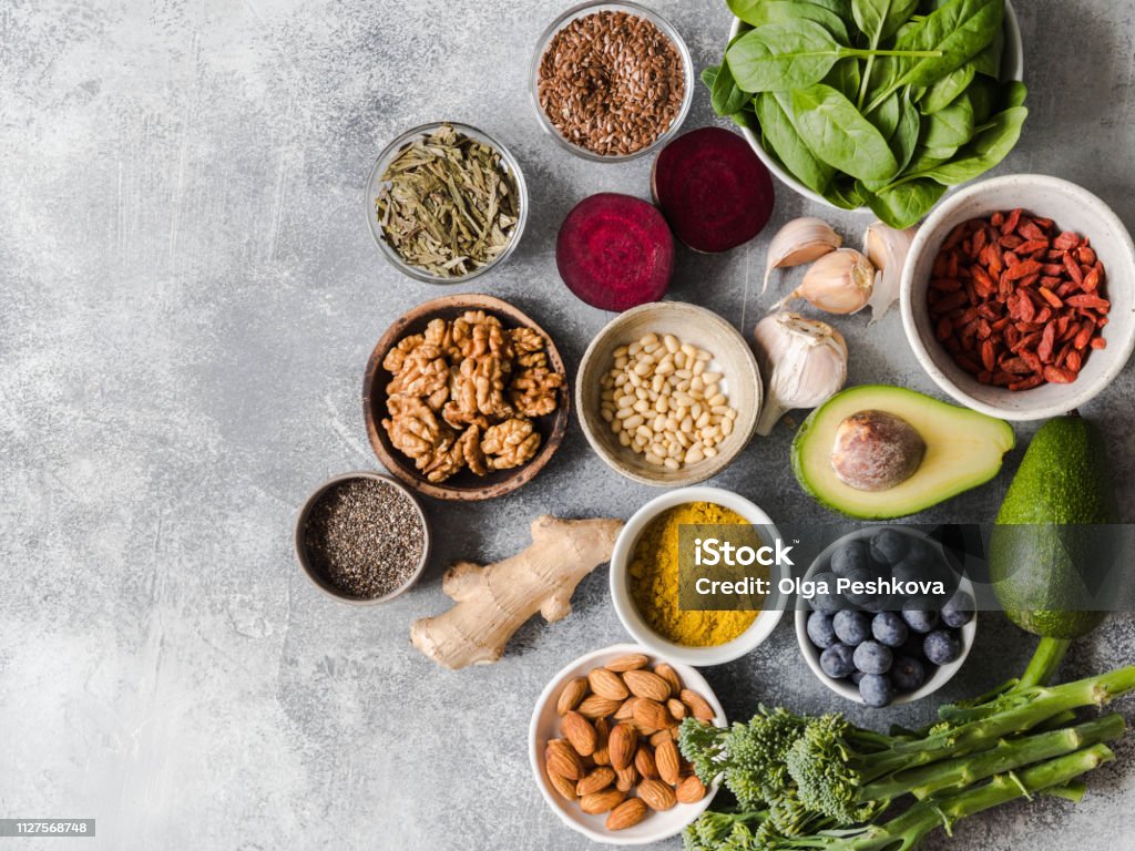 Healthy clean food - vegetables, fruits, nuts, superfoods on a gray background. Healthy eating concept. Top view. Healthy clean food - vegetables, fruits, nuts, superfoods on a gray background. Healthy eating concept. Healthy Eating Stock Photo