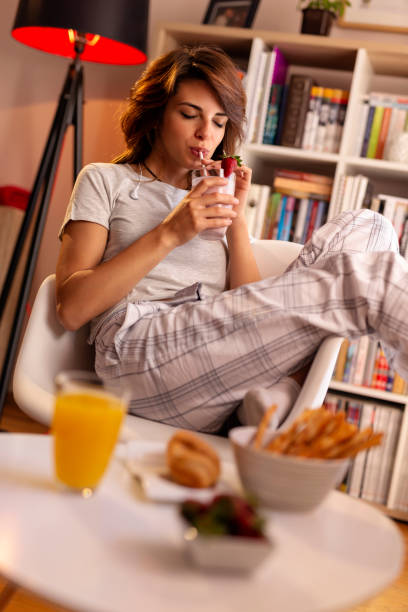 istock Woman drinking strawberry smoothie 1127572691