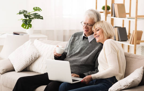 istock Mature couple browsing internet and drinking coffee 1127572881