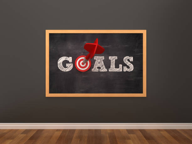 istock Chalkboard with GOALS Word with Target and Dart in Room - 3D Rendering 1127574290