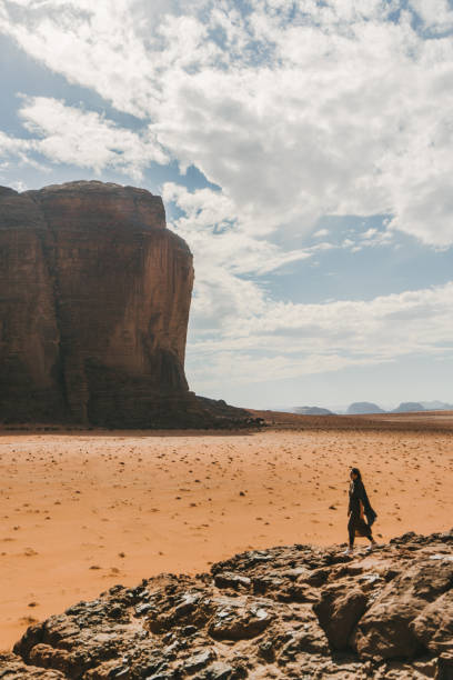 istock Woman looking at  Wadi Rum desert from rock 1127575148