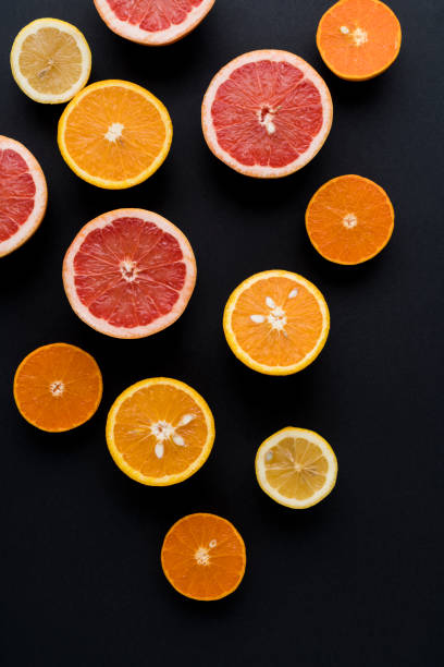 istock Orange, Grapefruit, Mandarine And Lemon Fruit On Black Background 1127575361