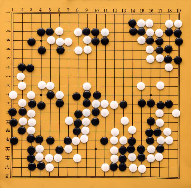 top view on a go board. desk for board game go and black and white bones. traditional asian strategy board game. atomic bomb game. the game of go view from above. - clothing traditional culture chinese culture black imagens e fotografias de stock
