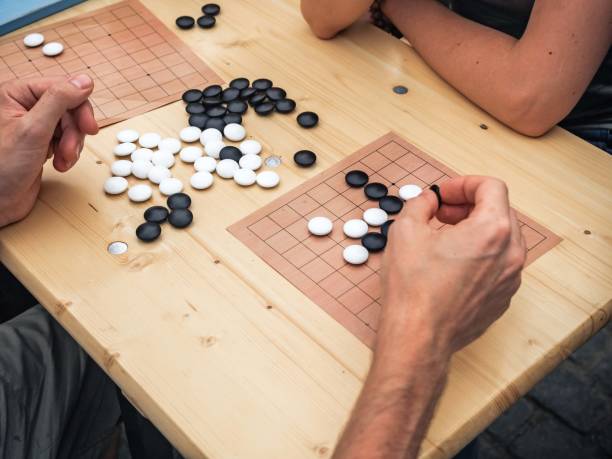 istock People playing Chinese board game. People Playing Mahjong Asian Tile-based Game. Table Gambling top view The game of go view from above. 1127576610