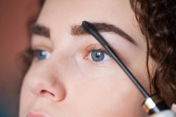 istock Young woman undergoing eyebrow correction procedure. Eyebrow Mascara 1127577115