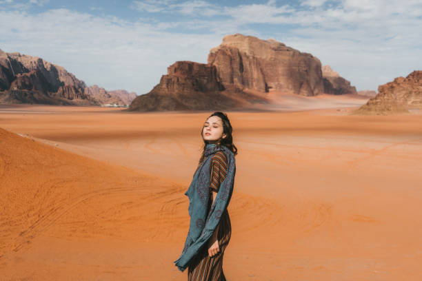 istock Woman standing and  looking at  Wadi Rum desert from rock 1127577173