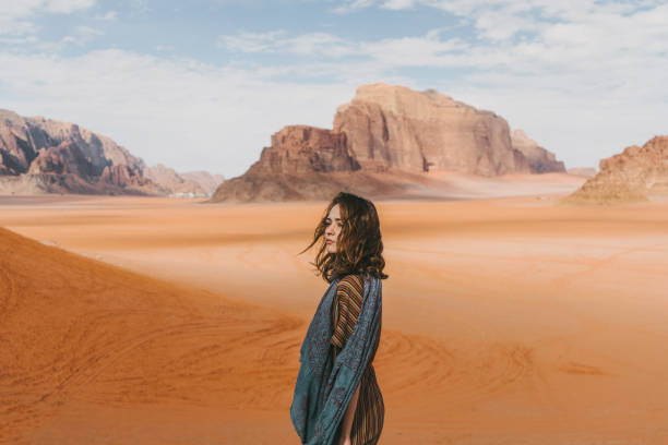 istock Woman standing and  looking at  Wadi Rum desert from rock 1127577339
