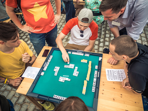 Moscow, Russia - August 09, 2018: Japanese festival in Moscow. Young people playing mahjong asian tile-based game. Table gambling top view.