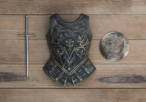istock sword and shield on wooden background 1127578525