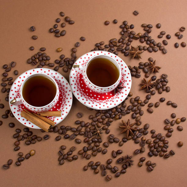 istock two spicy black coffee polka dot mugs and coffee beans mess 1127579037