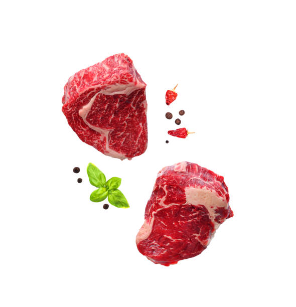 Raw marbled ribeye steaks isolated on white stock photo