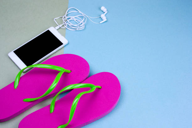 istock top view flat lay smartphone and pink flip flops 1127579316