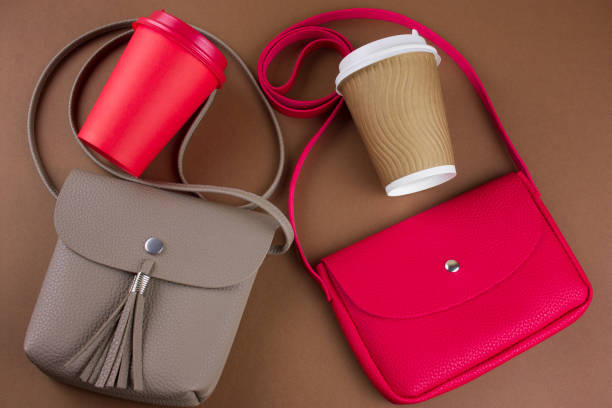 istock red and beige leather bags and take away drinks top view  on a brown  background 1127579892