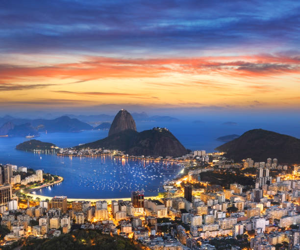Aerial view of Rio de Janeiro Brazil with Guanabara Bay and Sugar Loaf at night Aerial view of Rio de Janeiro Brazil with Guanabara Bay and Sugar Loaf at night copacabana rio de janeiro photos stock pictures, royalty-free photos & images