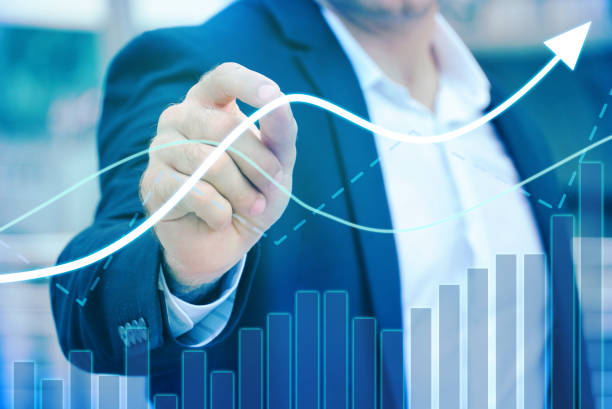 istock Businessman 's hand control trendline and volume chart 1127580606