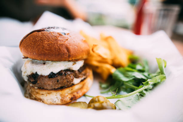 tasty hamburger with french fries on table - beer hamburger american culture beef imagens e fotografias de stock