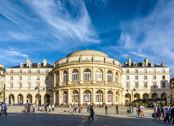 Front view of the opera house of Rennes, France. Rennes, France - October 13, 2018: Front view of the rounded facade of the opera house with people strolling on the pedestrian cobbled square by a sunny saturday afternoon under a deep blue sky. rennes france photos stock pictures, royalty-free photos & images